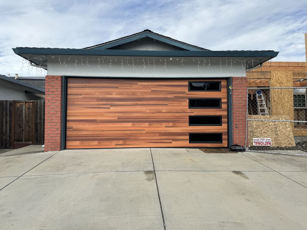 Light wood-grain garage door with modern trim windows